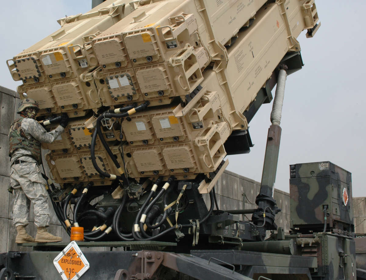 SPC Daniel Nebrida of C Battery, 1st Battalion, 43rd Air Defense Artillery - part of the 35th ADA Brigade - in Osan, Korea, checks canister cable connections on a "live" Patriot missile system positioned toward North Korea.